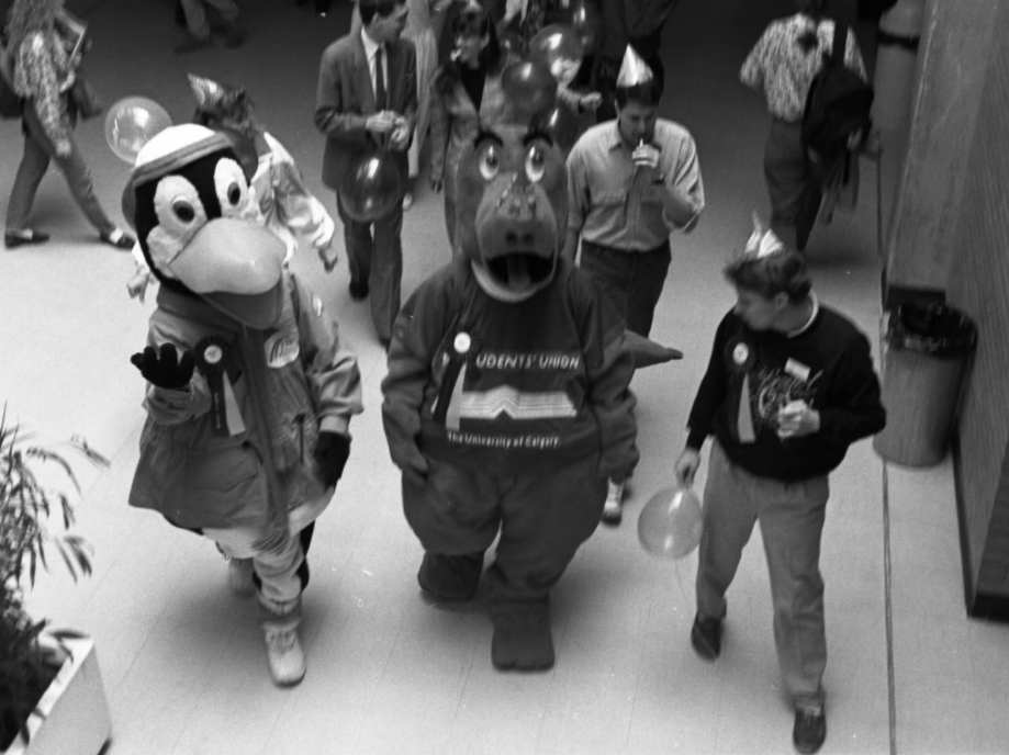 Image of Dexter  the Dinosaur, the University of Calgary mascot, during the university's 25th anniversary celebration.