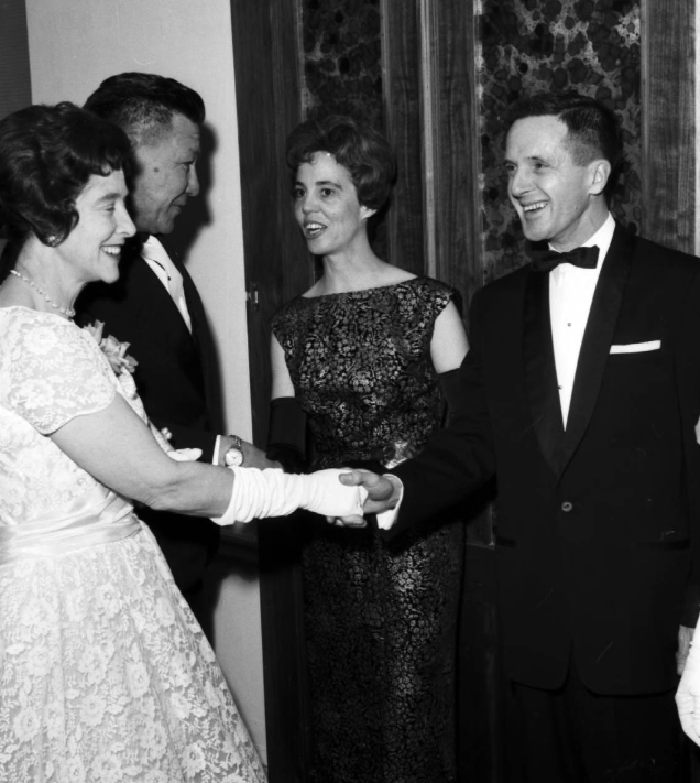 Image of Marjorie Norris, president of the Faculty Women's Club at the University of Alberta, Calgary and her husband Dr. Stanley Norris greet Mr. and Mrs. Lawrence Whitney to the inaugural Faculty Women's Club inaugural ball held at the Palliser Hotel.