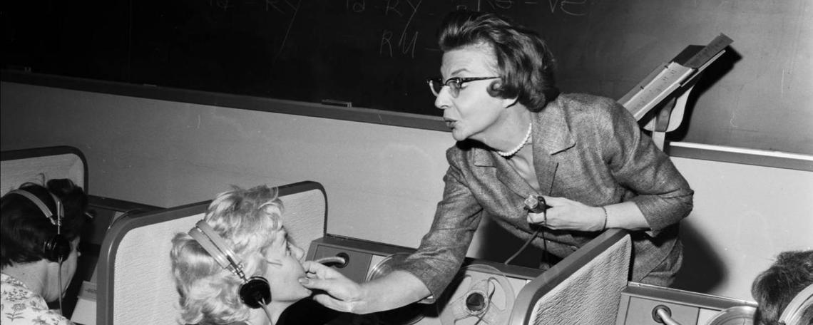 Image of French lecturer, Germaine L'Abbe, helping student Beryl Woodward with pronunciation