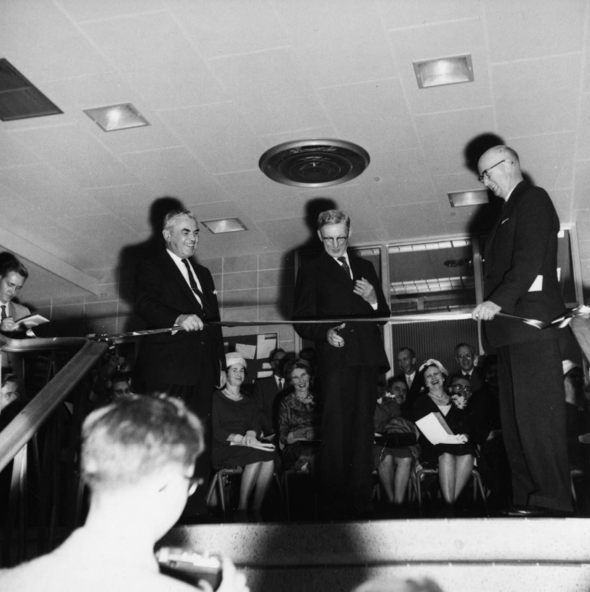 Image of Alberta Chief Justice Clinton J. Ford preparing to cut the ribbon to officially open the Arts and Education building as Dr. W. Johns, president of the University of Alberta (left), and Minister of Public Works James Hartley look on.