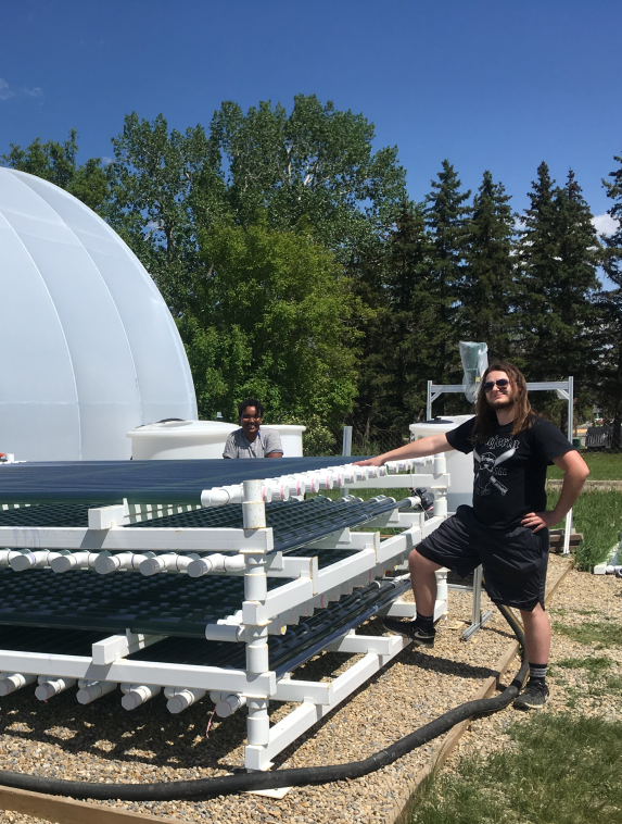 Undergraduates Bethlehem Mentie and Jeremy Ohlhauser at the bioenergy pilot plant in 2019.