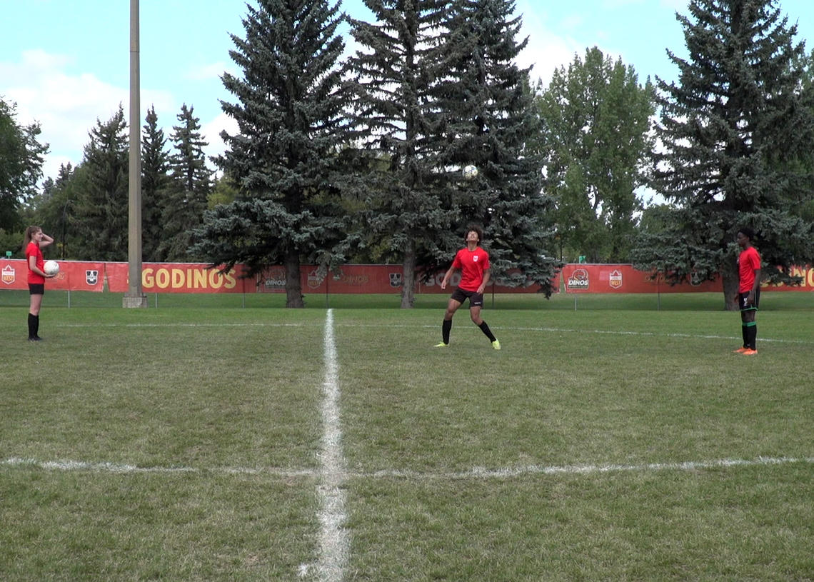 Soccer players receiving toss overhead and using eye tracking