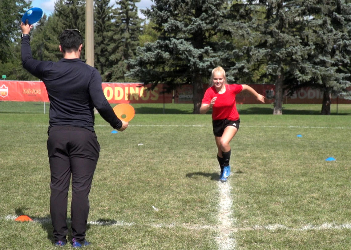 Soccer athlete and coach performing quick start and stops