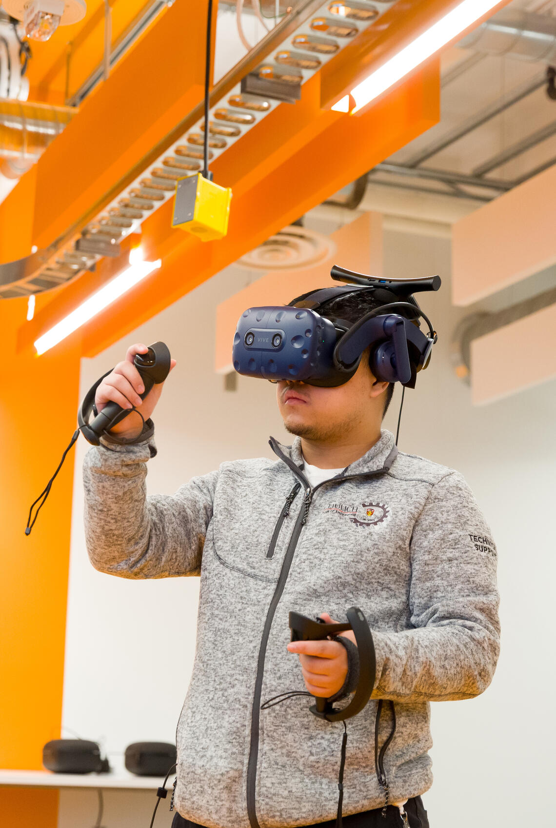 Student interacting with virtual reality technology in a lab.