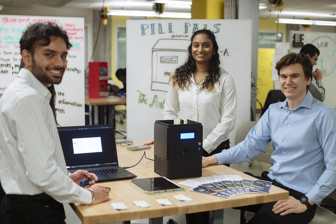 Students in an engineering class pose with their prototype.