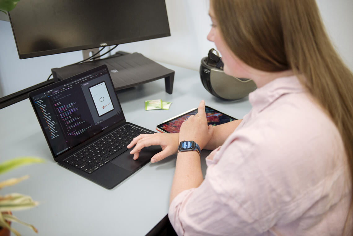 Looking over the shoulder of a student at a laptop screen.