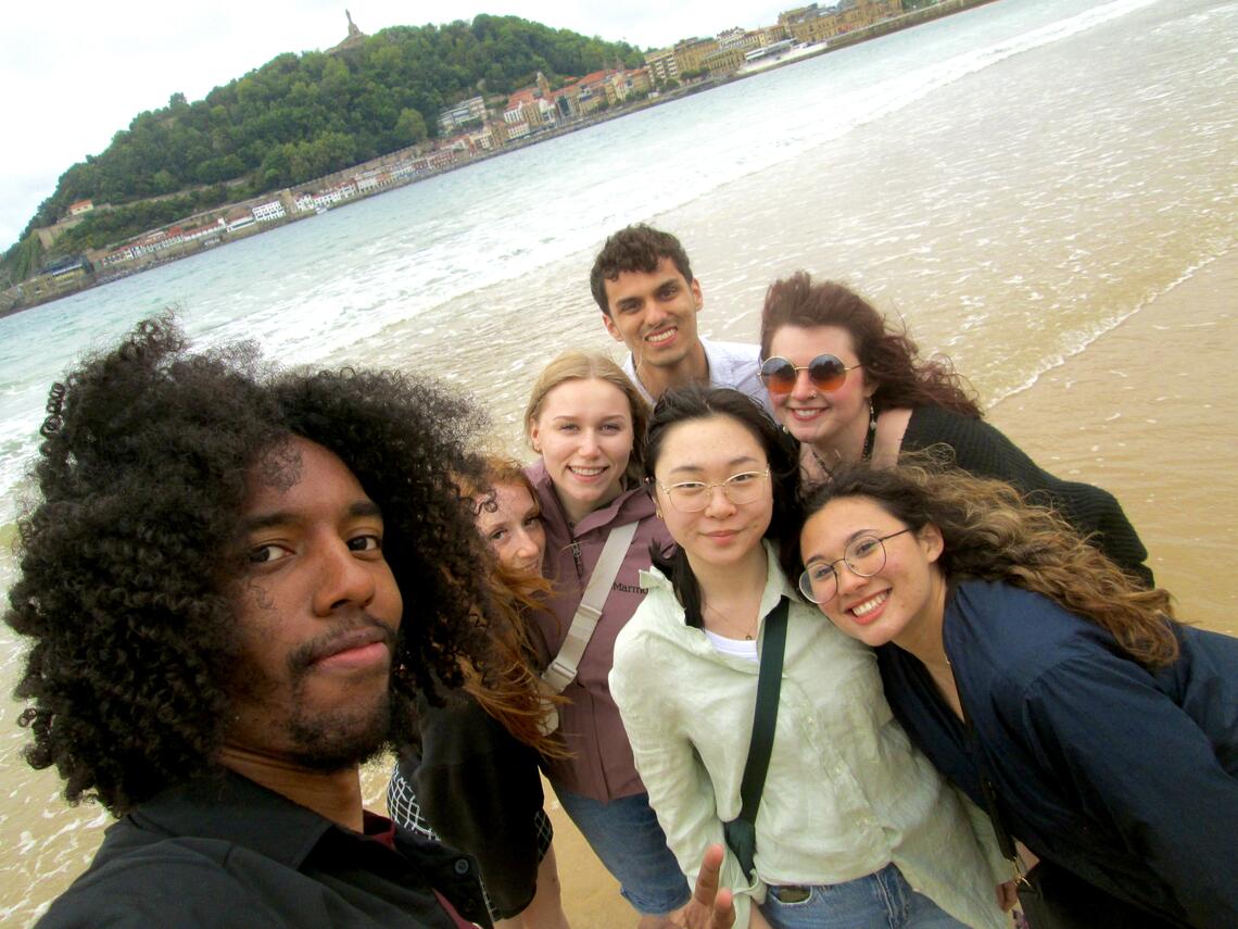 A selfie with a group of students on a beach in Spain.