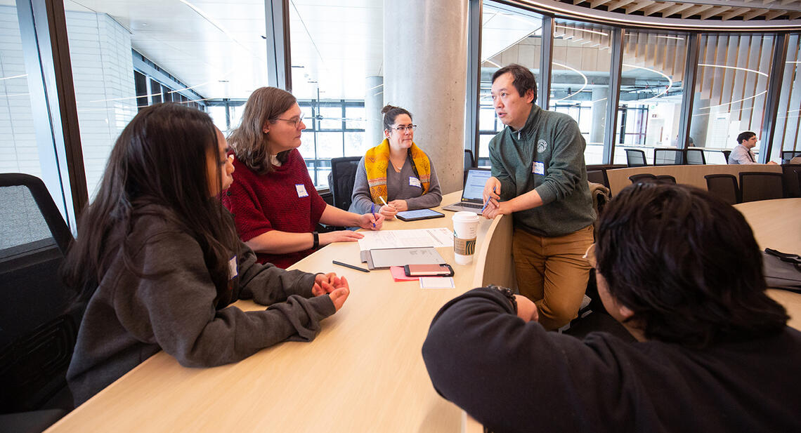 Group of staff participating in a conversation in the Viewpoint circle for dialogue room in Mathison Hall.