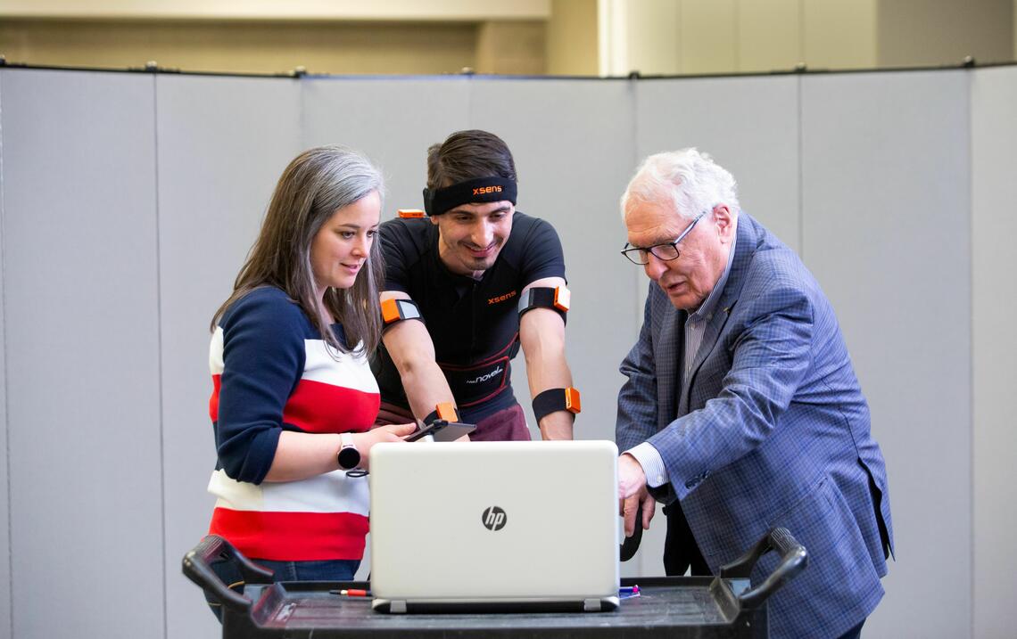 People around a laptop