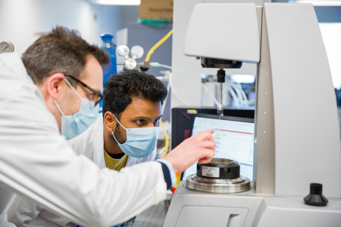 People working with lab equipment