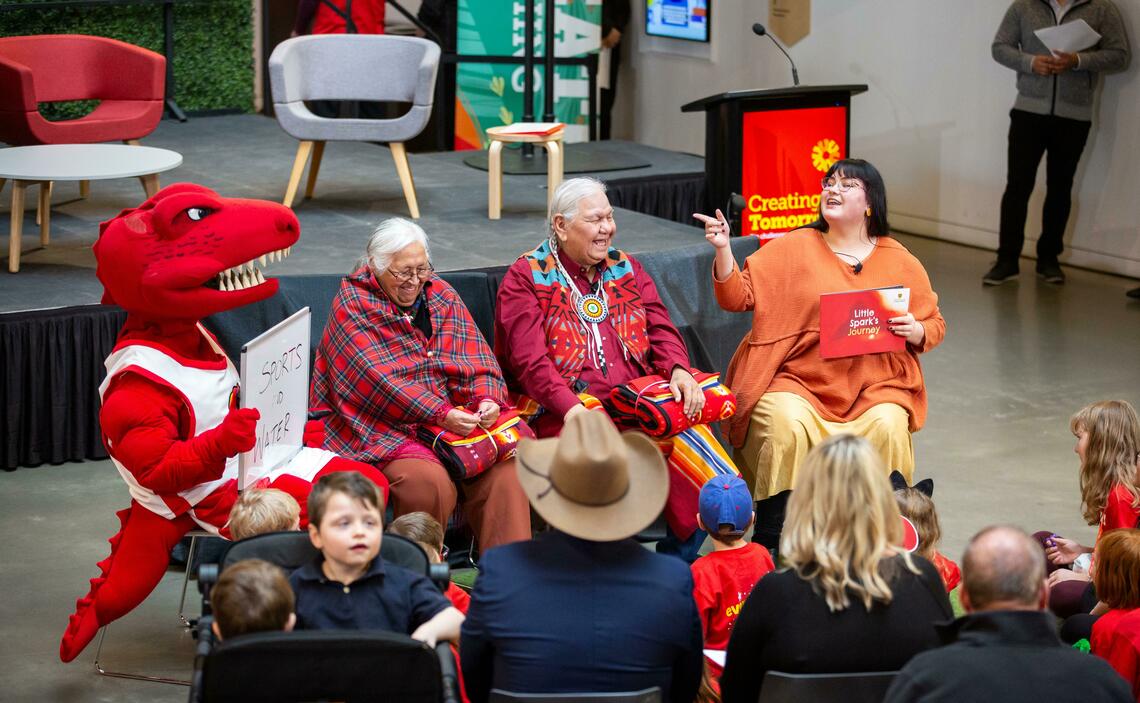 Community event, Rex dino mascot costume on the left