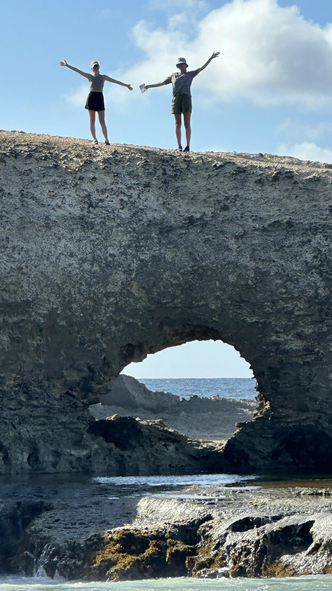 Student sitting on top of an arch