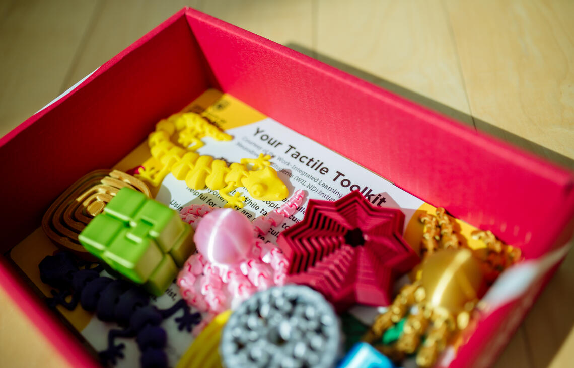 a box labelled Tactile Toolkit containing a variety tactile tools 