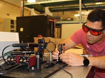 Behnam Ashrafkhani working on a laser ablation source.