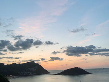 A sunset from a clifftop overlooking the ocean in Spain.