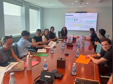 Students gathered around a board room table