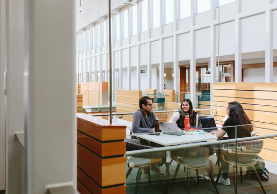 Students sit around a table at the Taylor Institute for Teaching and Learning.