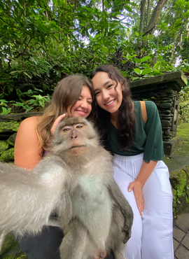 Selfie of two students with a monkey