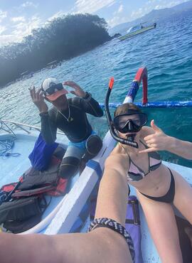 Selfie of two students with snorkel masks on a boat