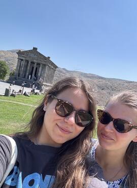 Students posing in front of a temple