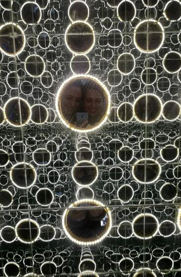 Student taking a selfie in mirrors 