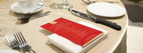 Red menus placed on a beautiful banquet table setting