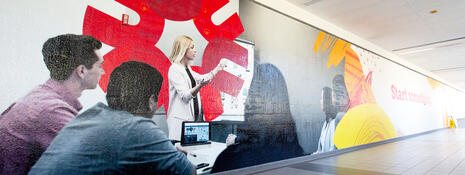 Long, large mural of a classroom and Start something graphics