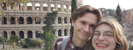 Couple posing in front of the colosseum in Rome