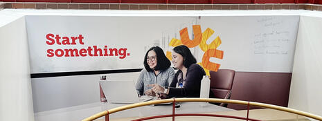 Graphic of two students with the Start something wordmark and spark