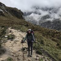 A young woman on a hiking path on a mountain.