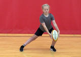 Athlete performing side lunge with arm circles exercise