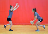 Athletes performing squat pass with jump catch exercise