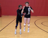 Athlete performing jumps with partner bumps exercise with a 2-leg landing