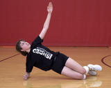 Athlete performing side plank torso rotation exercise with knee support