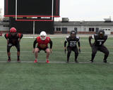 Football athletes performing dynamic squats