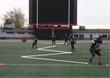 Football athletes performing zig-zaq runs