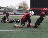 Football athletes performing nordic hamstring curl