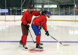 Hockey players performing partner bobbleheads exercise on a hockey rink