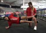 Athlete performing a foot-supported copenhagen adductor exercise in an ice hockey arena