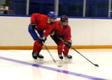 Hockey players performing shoulder to shoulder skate exercise on a hockey rink