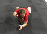 Athlete performing front plank with arm lifts exercise