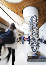 Students walking past the Zipper sculpture