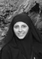 Happy young woman wearing a black khimar