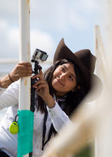Zeanna Janmohamed, a second-year veterinary medicine student, assists in studying the welfare of bucking bulls at the 2019 Calgary Stampede