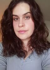 young woman with long dark brown hair in a light blue shirt