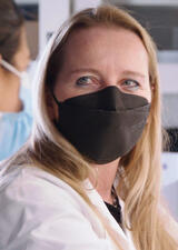 Kathy McCoy in lab wearing face mask 