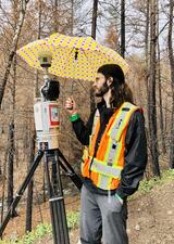 Mike is protecting our laser scanner from the rain, hail, and snow