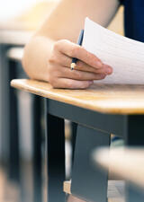 Student sitting at a desk to write an exam