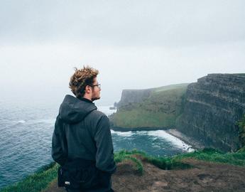 Image of student standing along cliffs of Scotland