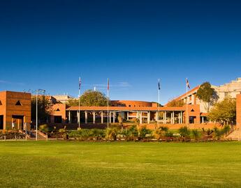 Curtin campus orange buildings with grassy plaza